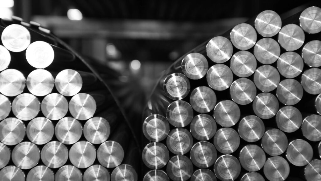 Close-up of bundled round metal bars in a warehouse.