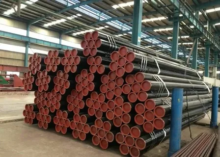 Bundled steel pipes stacked inside an industrial warehouse.
