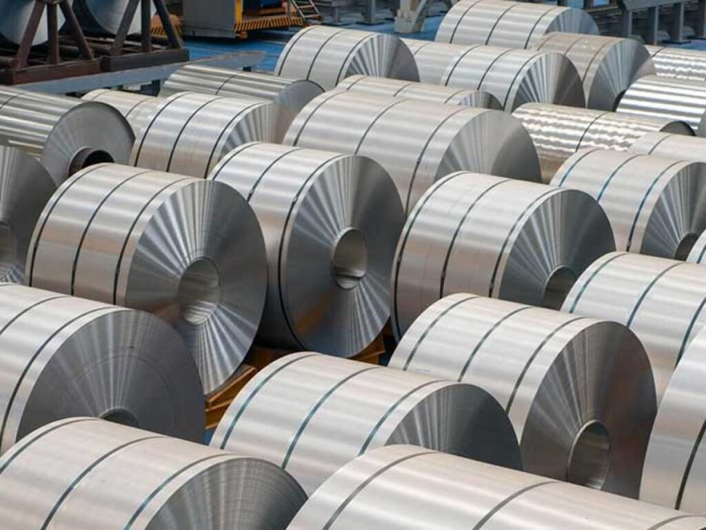 Rows of rolled steel coils stacked in a warehouse.